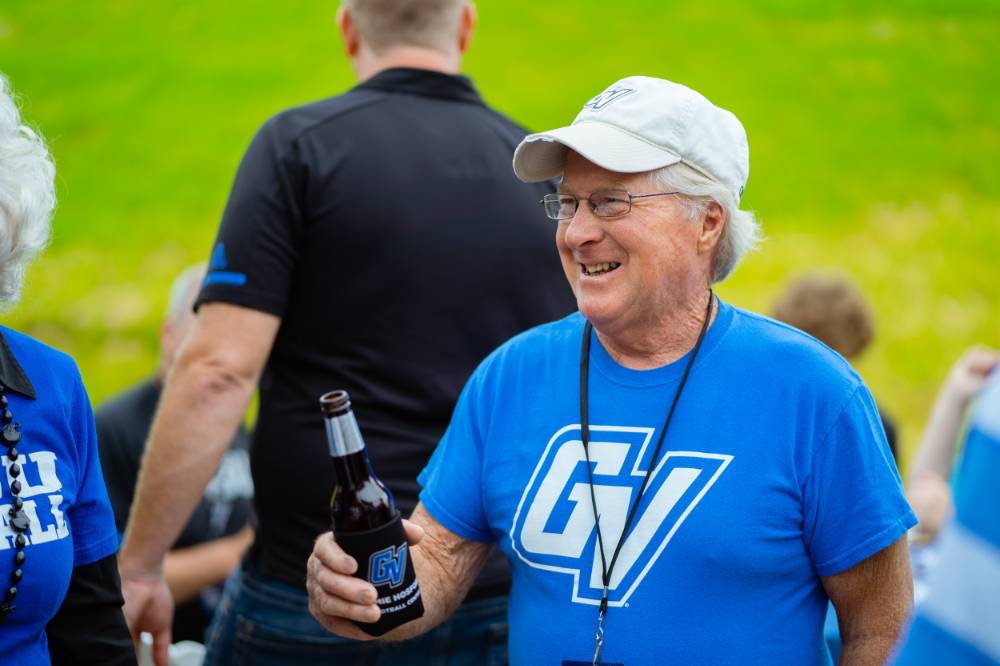 A guest holding a beer at the Jamie Hosford Football Center dedication.